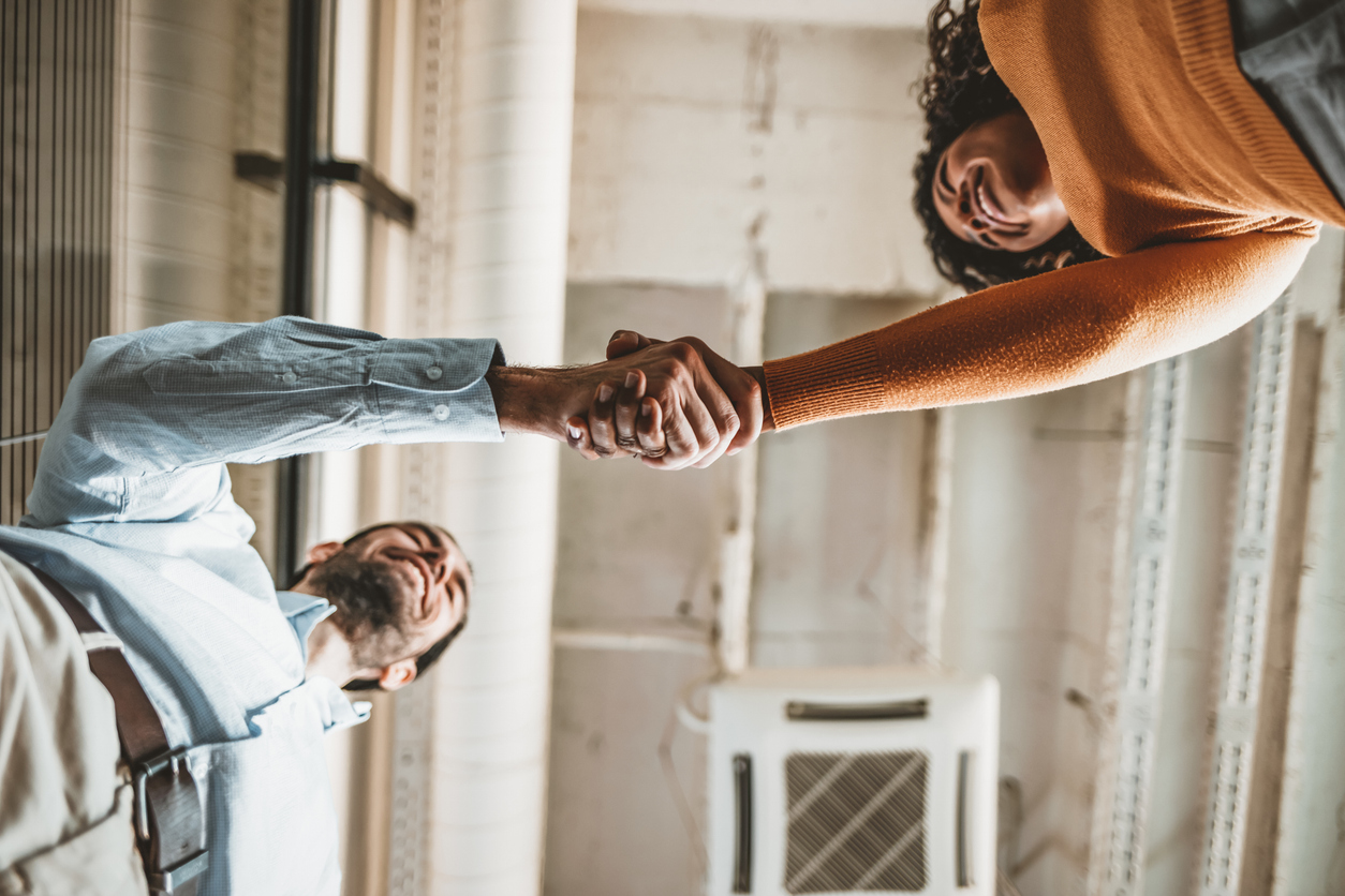 Businessman shaking woman's hand