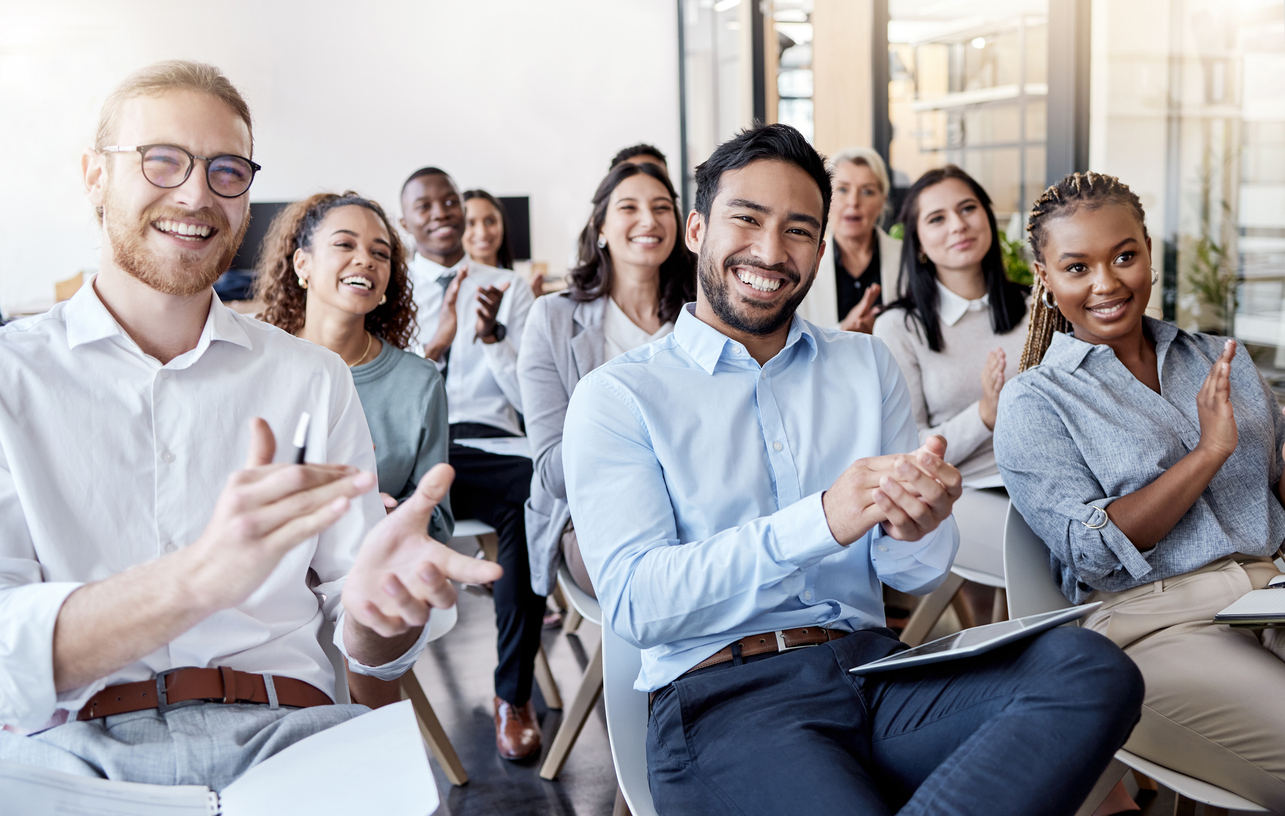 Shot of a group of businesspeople clapping hands during a conference